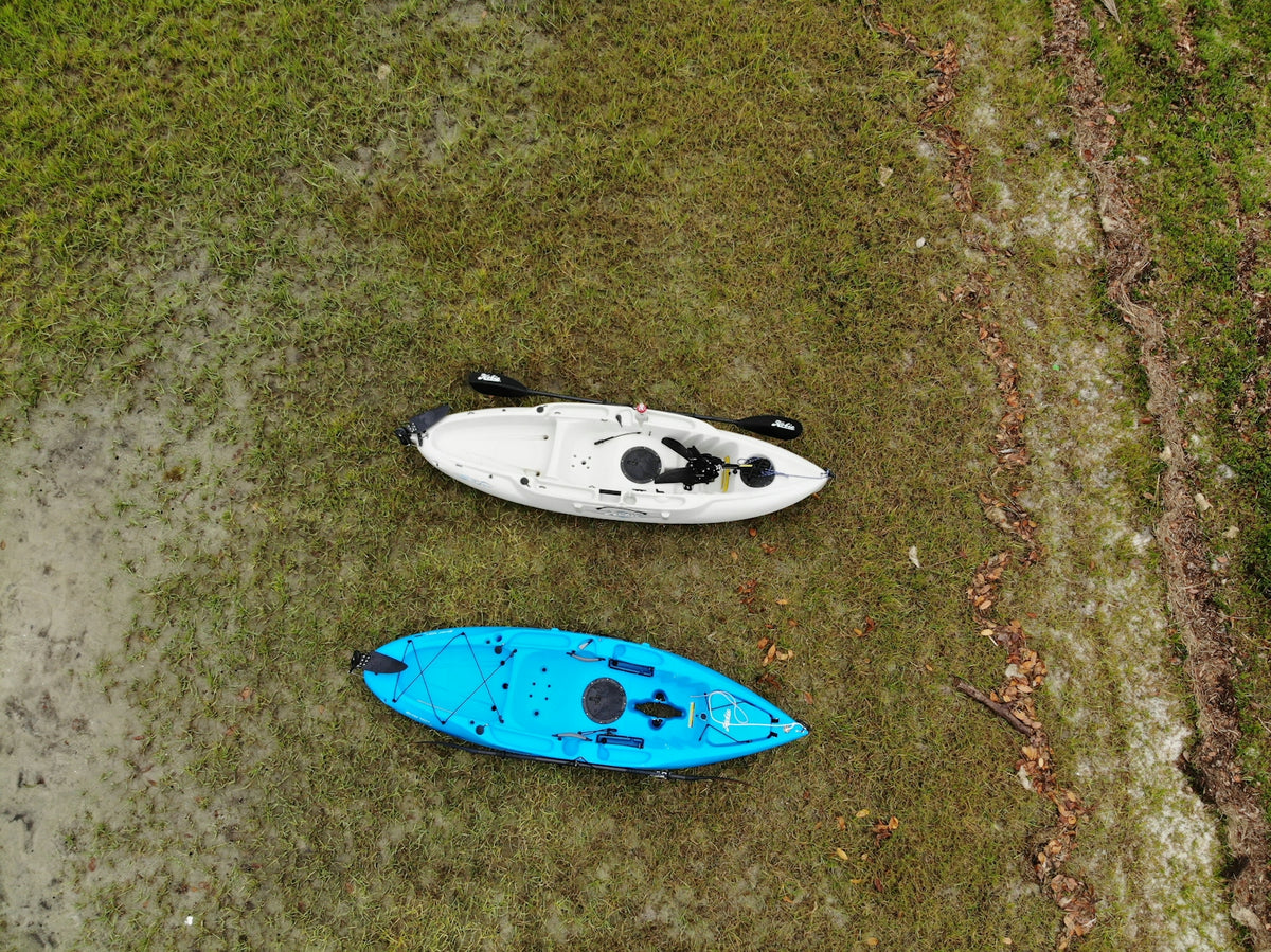 blue and white surfboard on gray sand