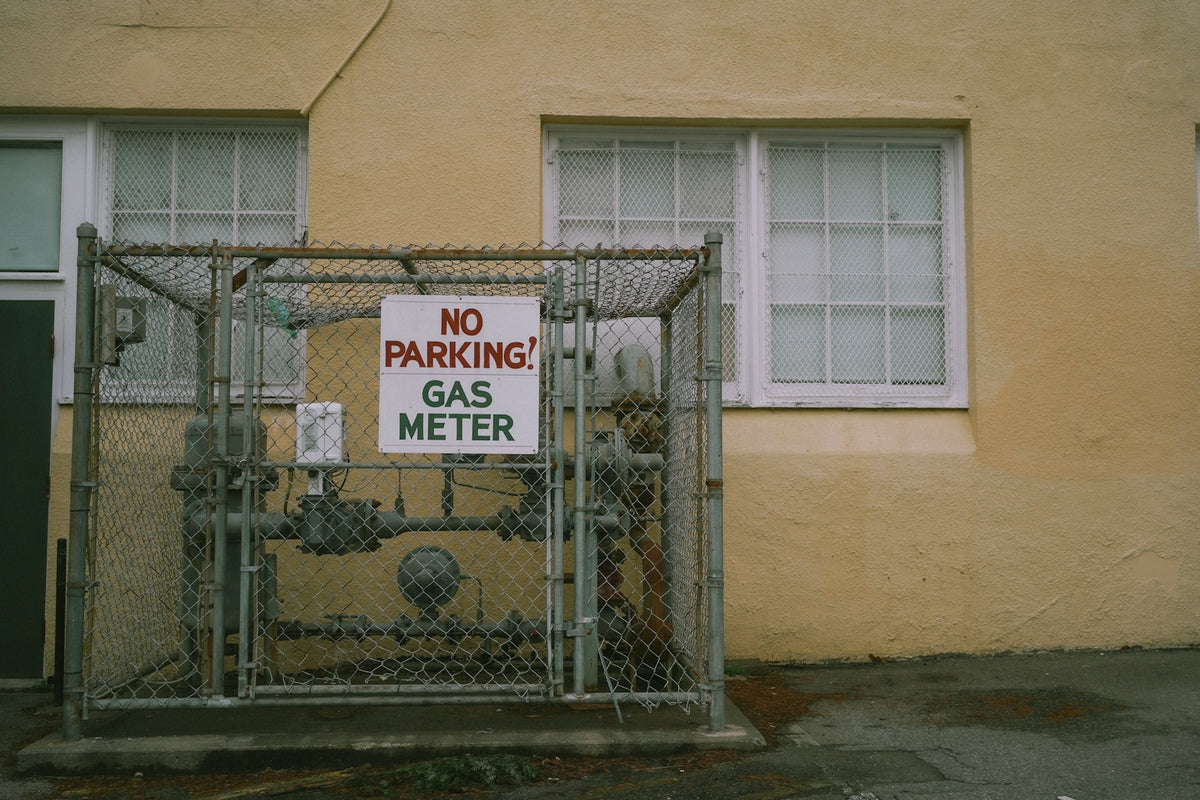 a no parking gas meter sign in front of a building