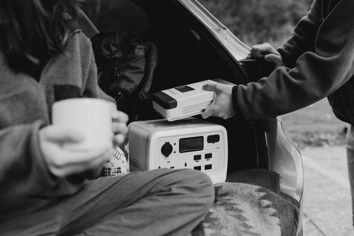 a person sitting in a car holding a cup