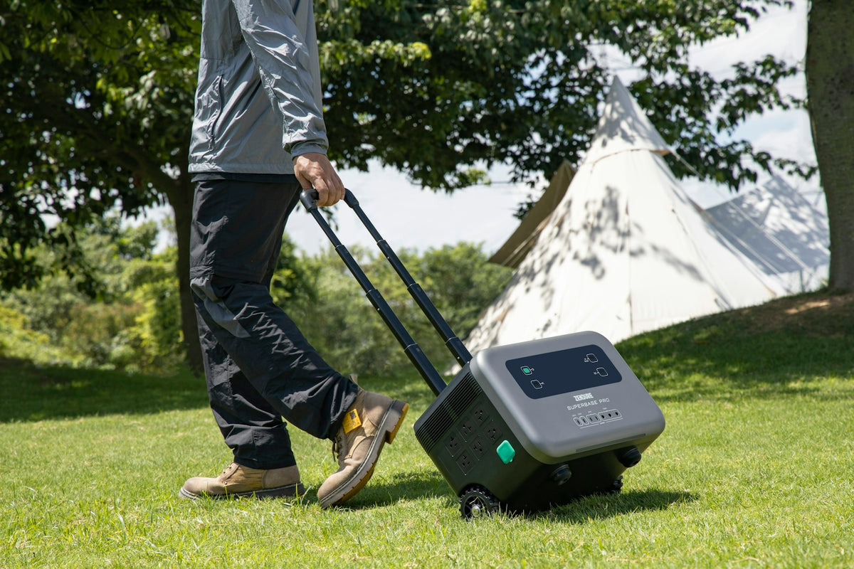 a man pulling a suitcase on wheels in the grass