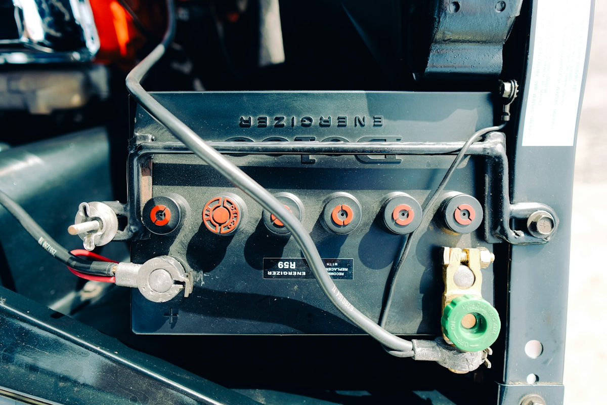 Close-up of a car battery with wires connected