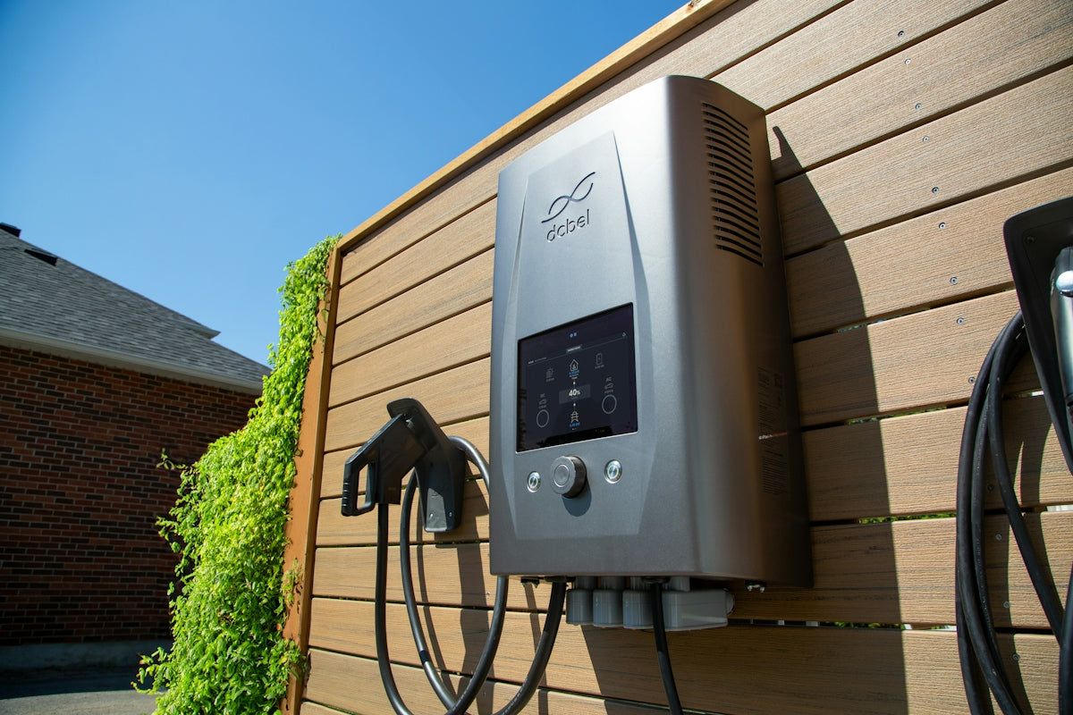 Electric car charger mounted on a wooden wall