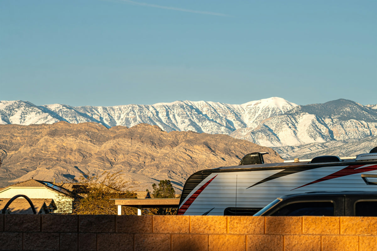 Snow-capped mountains behind a residential area and rv