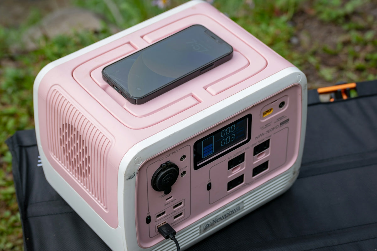 a pink and white radio sitting on top of a table