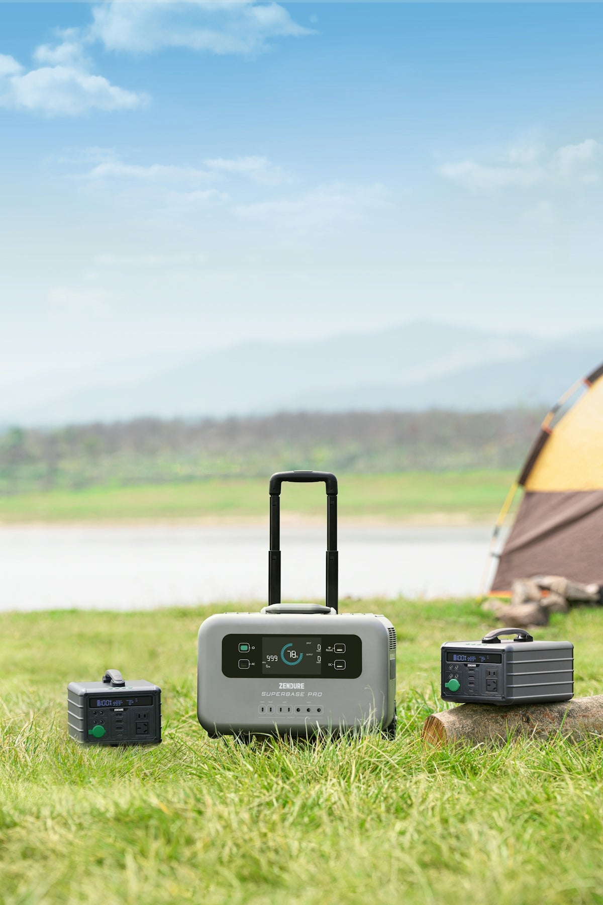 a piece of luggage sitting in the grass next to a tent
