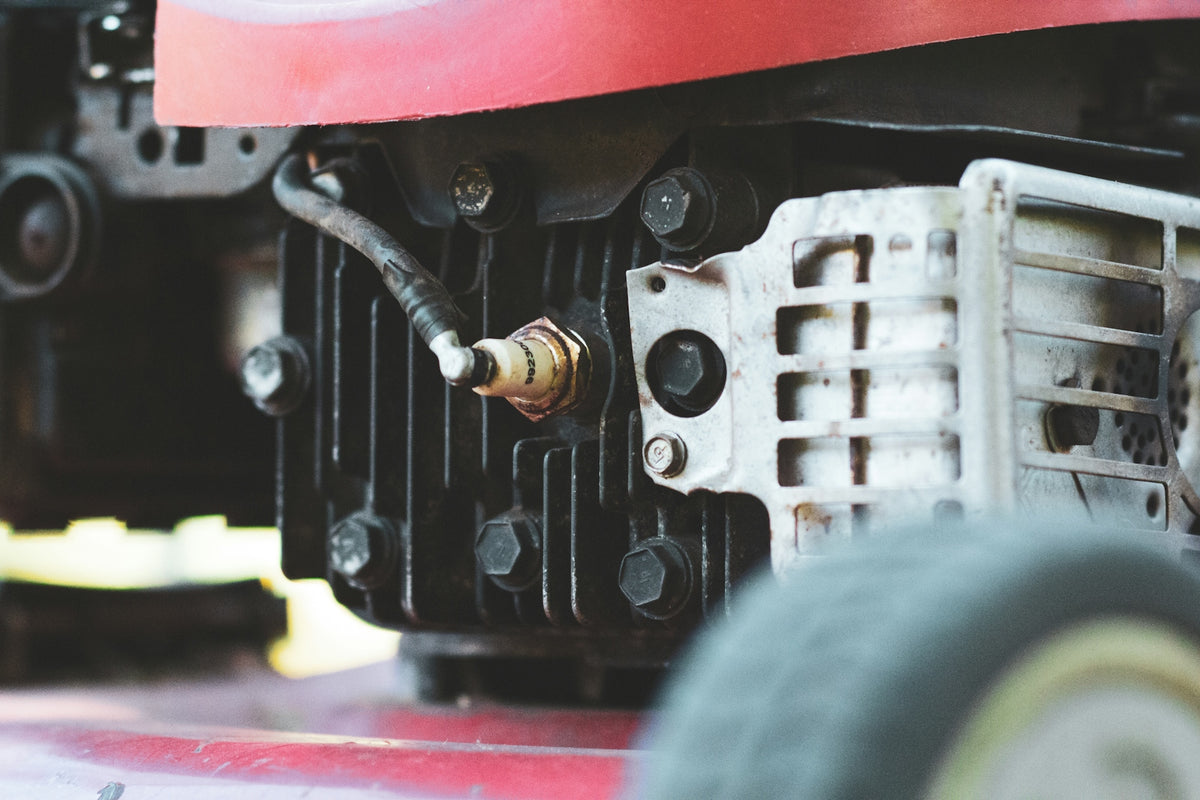 A close up of the engine of a lawn mower