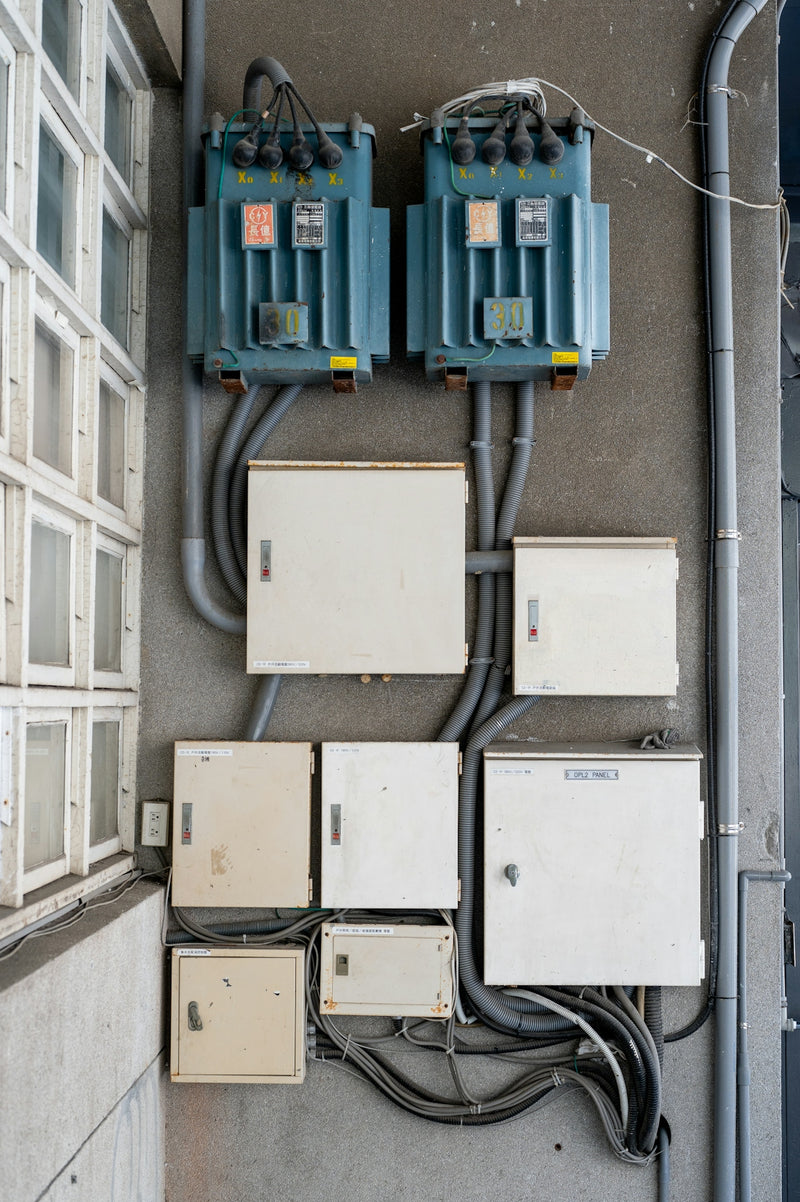 Electrical boxes and transformers mounted on a wall