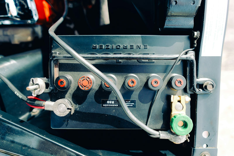Close-up of a car battery with wires connected